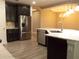 A kitchen featuring stainless steel appliances, dark cabinetry, and a center island with white countertops and tile flooring at 7486 Divot Loop # 7486, Bradenton, FL 34202