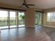 Spacious living room features sliding glass doors, tile flooring, and natural light at 7486 Divot Loop # 7486, Bradenton, FL 34202