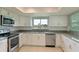 Bright kitchen with white cabinets, stainless steel appliances, and granite countertops at 8812 46Th W Ave, Bradenton, FL 34210