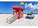 Lifeguard station featuring an American flag, patrol truck, and surfboards for safety and rescue operations at 12413 Osorio Ct # 103, Sarasota, FL 34238