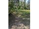Cleared backyard is shaded by mature trees at 39200 Cook Brown Rd, Punta Gorda, FL 33982