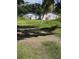 Exterior of a property featuring several weathered buildings on a grassy lot at 39200 Cook Brown Rd, Punta Gorda, FL 33982