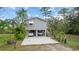 Charming stilt home with covered parking and lush tropical landscaping at 39200 Cook Brown Rd, Punta Gorda, FL 33982