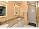 Bathroom featuring a double vanity with granite countertop and glass-enclosed shower at 5281 Mahogany Run Ave # 822, Sarasota, FL 34241