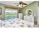 Comfortable bedroom with a water view, ceiling fan, and white wooden furniture at 5281 Mahogany Run Ave # 822, Sarasota, FL 34241