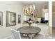 Dining area with modern lighting and an open view into the kitchen, bright and airy space at 5281 Mahogany Run Ave # 822, Sarasota, FL 34241