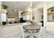 Open dining area with modern light fixture and seamless access to the kitchen, bright and open at 5281 Mahogany Run Ave # 822, Sarasota, FL 34241