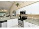 Well-lit kitchen boasting granite countertops and modern stainless steel appliances at 5281 Mahogany Run Ave # 822, Sarasota, FL 34241