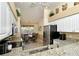 Kitchen view to the dining area with modern appliances and granite countertops, bright and open at 5281 Mahogany Run Ave # 822, Sarasota, FL 34241