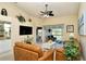 Bright living room with view to outdoor patio and a large TV, comfortable seating, plants at 5281 Mahogany Run Ave # 822, Sarasota, FL 34241