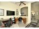 Home office with dual desks, television, and view of open living space at 5281 Mahogany Run Ave # 822, Sarasota, FL 34241
