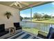 Screened in patio with wicker furniture overlooking the lake at 5281 Mahogany Run Ave # 822, Sarasota, FL 34241