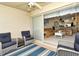 Enclosed patio with blue wicker furniture and views of the living room at 5281 Mahogany Run Ave # 822, Sarasota, FL 34241