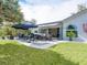 Inviting outdoor space featuring patio seating, a retractable awning, and lush landscaping at 536 Ketch Ln, Longboat Key, FL 34228