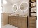 Bathroom with double sinks, decorative mirrors, and marble countertops at 536 Ketch Ln, Longboat Key, FL 34228
