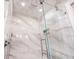 Beautiful shower featuring glass doors, marble tile, and a rainfall shower head at 536 Ketch Ln, Longboat Key, FL 34228