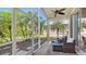 Enclosed outdoor lanai offering privacy and a view of lush, tropical landscaping and ceiling fans at 6422 42Nd E St, Sarasota, FL 34243