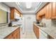 Galley kitchen featuring granite countertops and stainless steel appliances at 6703 Midnight Pass Rd # 108B, Sarasota, FL 34242
