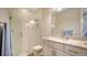 Stylish bathroom with a glass shower, white cabinetry, and granite countertop sink at 7668 Registrar Way, Sarasota, FL 34243