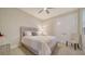 Bedroom with neutral decor, a bed with a light gray headboard, and bright natural light at 7668 Registrar Way, Sarasota, FL 34243