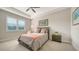 Cozy bedroom featuring soft, neutral tones, a comfortable bed, and ample natural light at 7668 Registrar Way, Sarasota, FL 34243