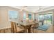 Elegant dining area with stylish furnishings and natural light flowing into the connected living space at 7668 Registrar Way, Sarasota, FL 34243
