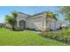 Beautifully landscaped single-Gathering home showcasing lush greenery and a well-maintained lawn at 7668 Registrar Way, Sarasota, FL 34243