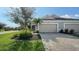 Charming single-Gathering home with a two-car garage, brick paved driveway, and neatly landscaped yard at 7668 Registrar Way, Sarasota, FL 34243