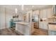 Modern kitchen featuring stainless steel appliances, light cabinets, and an island with a sink and granite counters at 7668 Registrar Way, Sarasota, FL 34243