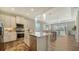 Modern kitchen featuring stainless steel appliances, granite countertops, and an island with a sink at 7668 Registrar Way, Sarasota, FL 34243