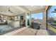 Covered patio area with a sliding glass door leading to a stylishly furnished living room at 7668 Registrar Way, Sarasota, FL 34243