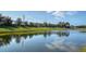 Scenic view of a tranquil pond reflecting the sky and surrounding trees at 7668 Registrar Way, Sarasota, FL 34243