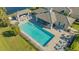 Relaxing community pool area with lounge chairs and shaded seating, perfect for leisure and socializing at 7668 Registrar Way, Sarasota, FL 34243