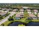 Aerial view of homes with pools and green space in a community with mature landscaping at 8737 Pebble Creek Ln, Sarasota, FL 34238