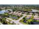An aerial view displays homes with private pools, surrounded by lush landscapes and ponds at 8737 Pebble Creek Ln, Sarasota, FL 34238