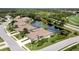 An aerial shot showcases homes with screened-in lanais surrounding a serene pond at 8737 Pebble Creek Ln, Sarasota, FL 34238