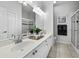 Bathroom with double sink vanity, granite countertop, and glass door shower at 8737 Pebble Creek Ln, Sarasota, FL 34238