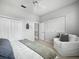 Bright bedroom featuring a comfortable chair, neutral walls, and natural light from window at 8737 Pebble Creek Ln, Sarasota, FL 34238