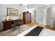 Bedroom with hardwood flooring, wardrobe and french doors leading to another room at 8737 Pebble Creek Ln, Sarasota, FL 34238