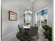 Bright dining area featuring a chandelier, round table, and shuttered windows at 8737 Pebble Creek Ln, Sarasota, FL 34238