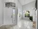 Entryway featuring transom windows, chandelier and tile flooring at 8737 Pebble Creek Ln, Sarasota, FL 34238