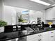 Modern kitchen featuring granite countertops and a seamless view to other parts of the house at 8737 Pebble Creek Ln, Sarasota, FL 34238