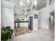 Modern kitchen with white cabinets, stainless steel appliances, and a view of the lush outdoors through a large window at 8737 Pebble Creek Ln, Sarasota, FL 34238