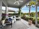 Inviting screened lanai with cozy furniture and lush landscaping, offering a serene outdoor retreat with lake views at 8737 Pebble Creek Ln, Sarasota, FL 34238