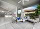 Relaxing screened lanai with comfortable seating, ceiling fan, and views of the backyard, perfect for outdoor living at 8737 Pebble Creek Ln, Sarasota, FL 34238