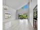Spacious living room with tile floors, high ceilings, natural light, and views of the outdoors at 8737 Pebble Creek Ln, Sarasota, FL 34238