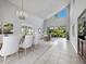 Bright living room with tile floors, a large window, and high ceilings, creating an inviting and airy atmosphere at 8737 Pebble Creek Ln, Sarasota, FL 34238