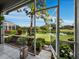 Relaxing screened patio with beautiful landscaping and water view at 8737 Pebble Creek Ln, Sarasota, FL 34238