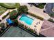 Aerial view of a pristine pool with lounge chairs, surrounded by lush landscaping and community amenities at 8737 Pebble Creek Ln, Sarasota, FL 34238