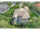 Aerial view of a beautiful home with a screened-in pool and lush landscaping in a serene neighborhood at 11432 Savannah Lakes Dr, Parrish, FL 34219